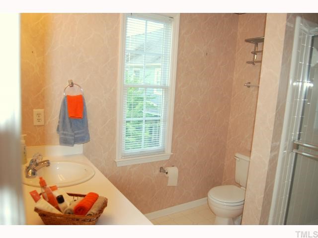 8320 Hempshire Place, Unit 101 Raleigh, NC 27613 - Photo 10 of 12 a bathroom with a toilet and a shower