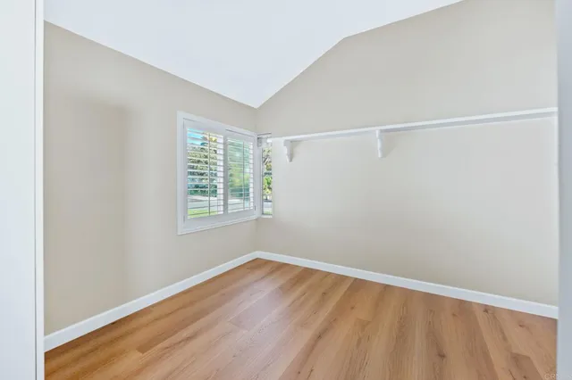 a view of a room with wooden floor and a window