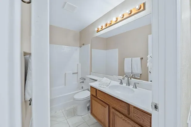 a bathroom with a double vanity sink mirror and toilet