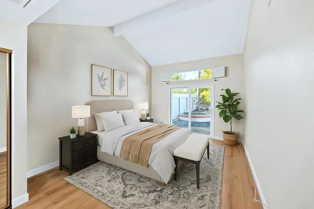 a bedroom with a bed and a potted plant