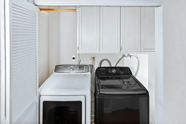 a kitchen with a stove and a white cabinet