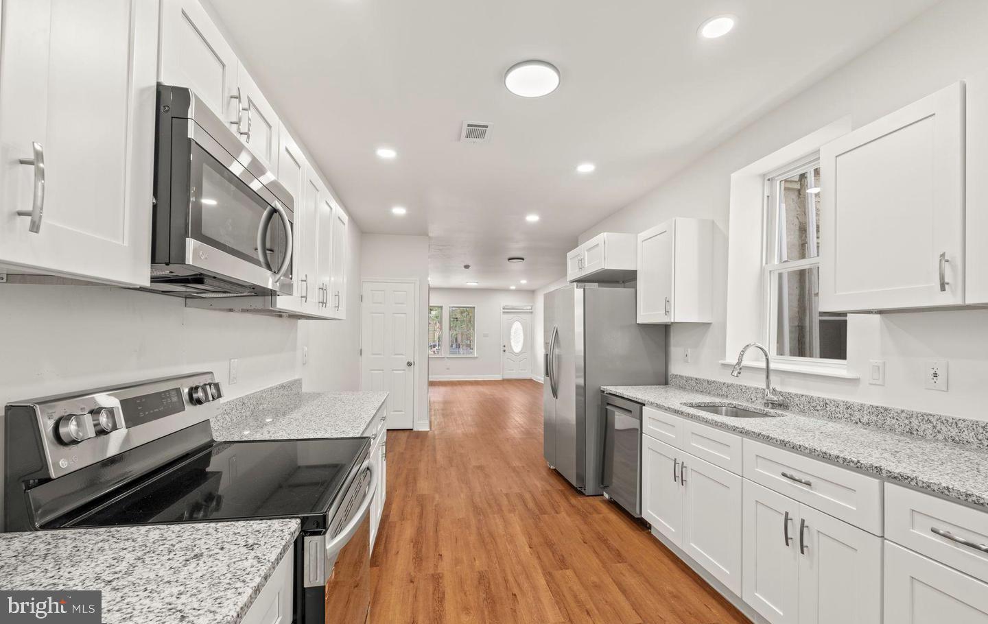 4847 Fairmount Avenue Philadelphia, PA 19139 - Photo 11 of 35 a large kitchen with stainless steel appliances granite countertop a lot of counter space and wooden floors