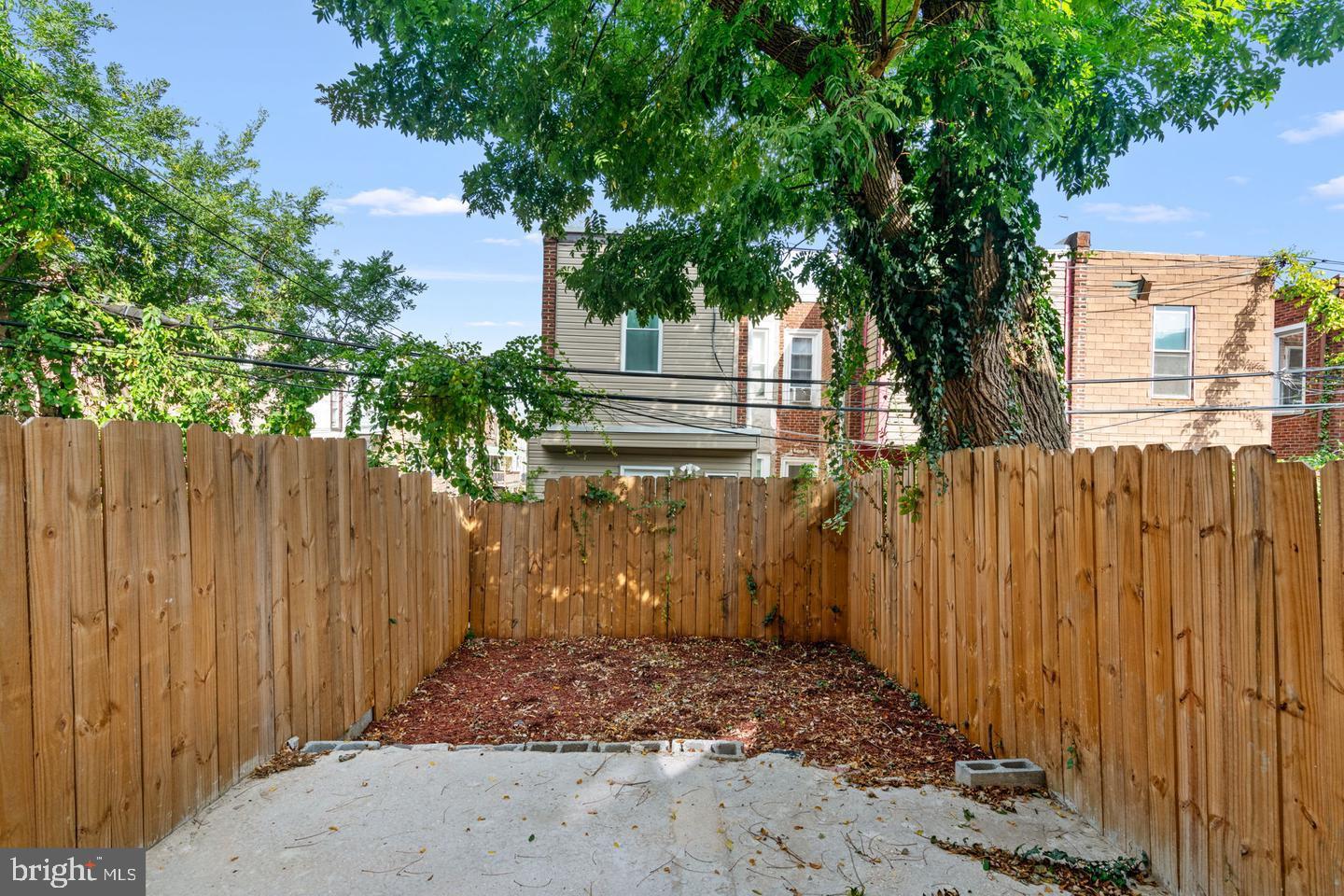4847 Fairmount Avenue Philadelphia, PA 19139 - Photo 33 of 35 a view of a house with a wooden fence next to a large tree