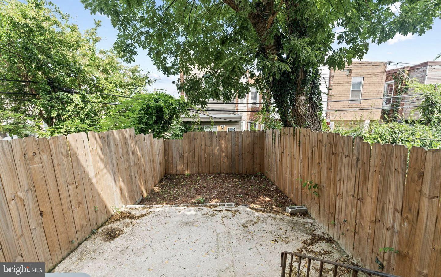 4847 Fairmount Avenue Philadelphia, PA 19139 - Photo 35 of 35 a view of a backyard with wooden fence and a large tree