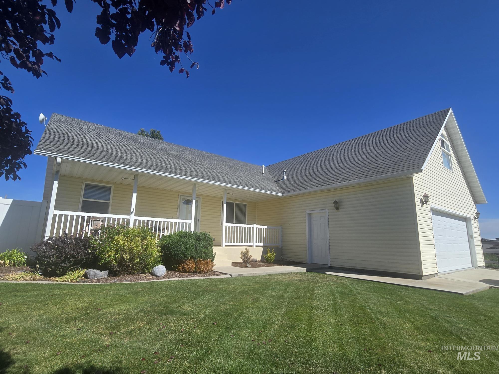 2480 West 9th Street Weiser, ID 83672 - Photo 7 of 17 Light yellow siding exterior with a covered porch featuring white railings