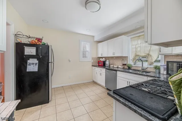 a kitchen with granite countertop a stove and a refrigerator