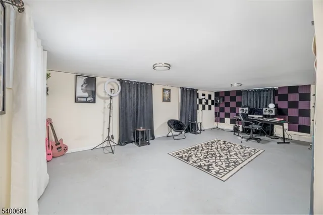 a view of a livingroom with workspace and a window