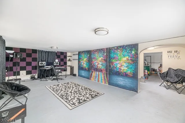 a living room with furniture and a book shelf