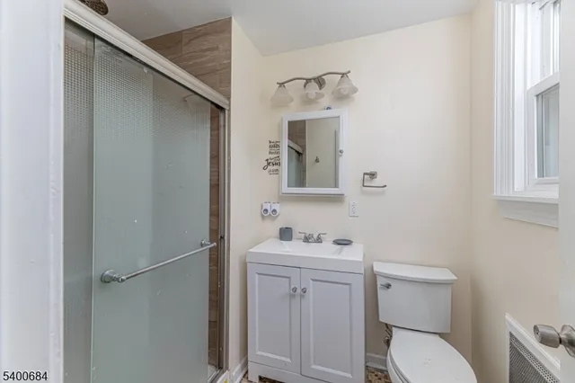 a bathroom with a toilet sink vanity and mirror