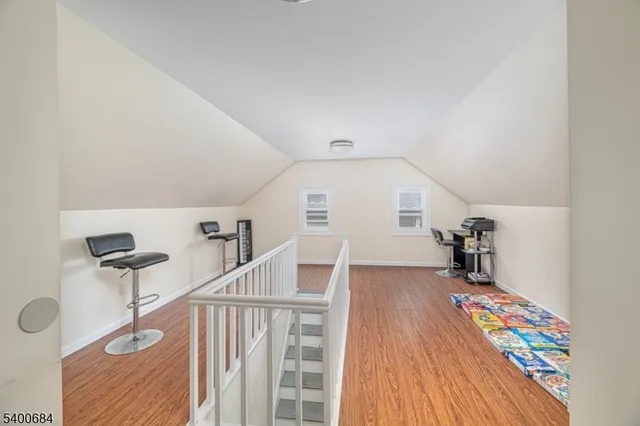 a view of entryway with stairs and wooden floor