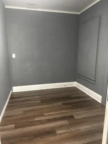 a view of room with wooden floor