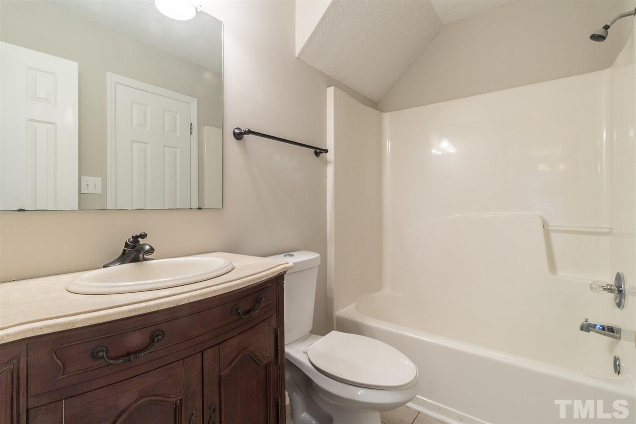 4451 Antique Lane Raleigh, NC 27616 - Photo 12 of 24 a bathroom with a sink a toilet and shower