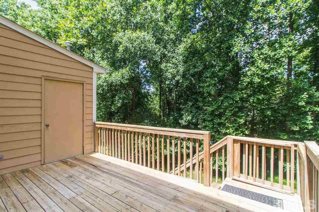 4451 Antique Lane Raleigh, NC 27616 - Photo 22 of 24 a balcony with wooden floor and yard in the back