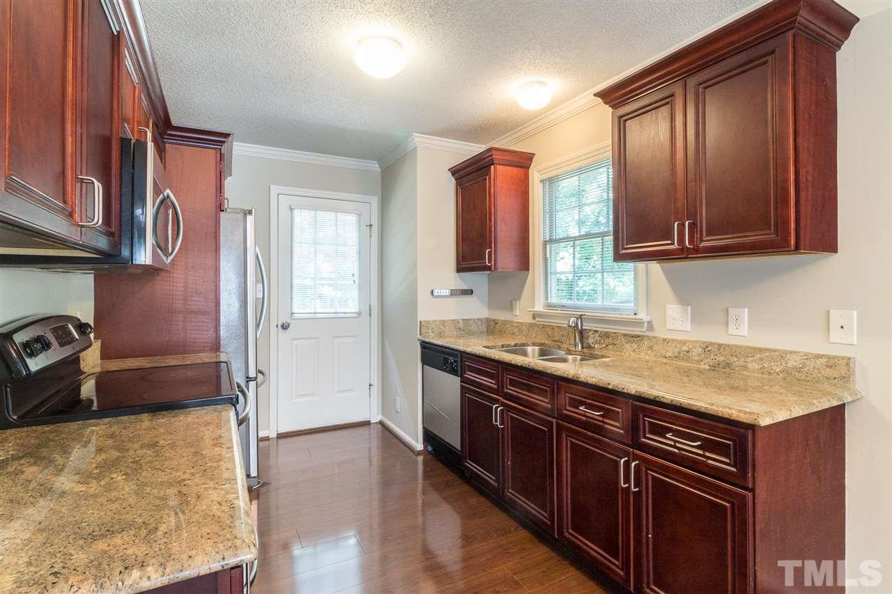4451 Antique Lane Raleigh, NC 27616 - Photo 9 of 24 a kitchen with stainless steel appliances granite countertop a stove and a sink