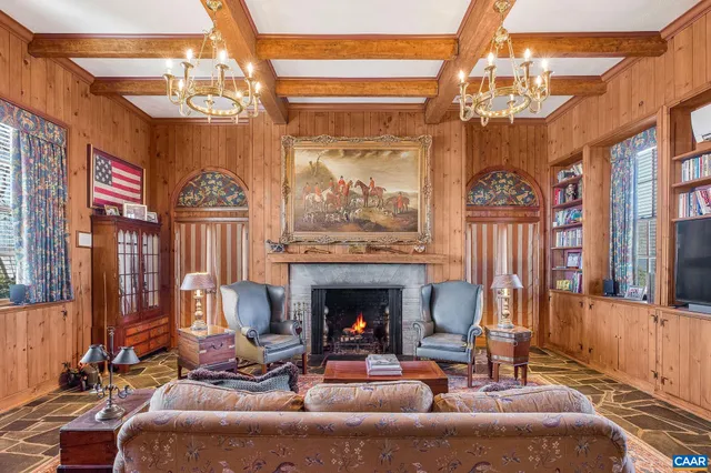 a living room with furniture and a book shelf