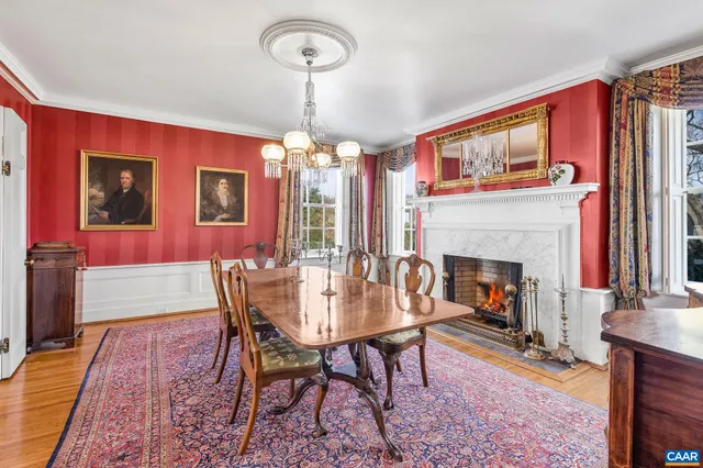 a kitchen with stainless steel appliances granite countertop a table chairs sink refrigerator and microwave