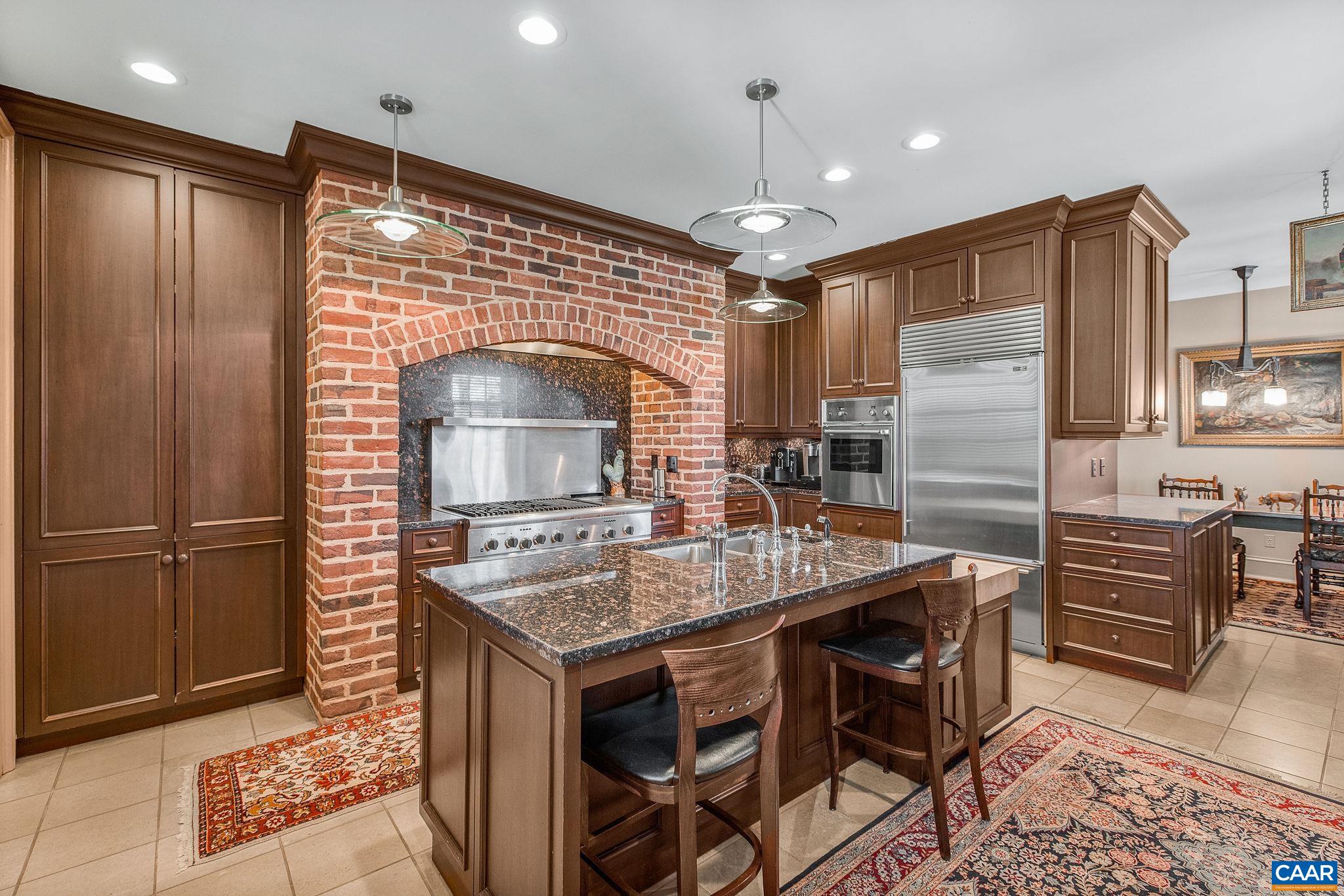 2328 Liberty Corner Road Esmont, VA 22937 - Photo 23 of 75 a kitchen with stainless steel appliances granite countertop a table chairs sink refrigerator and microwave