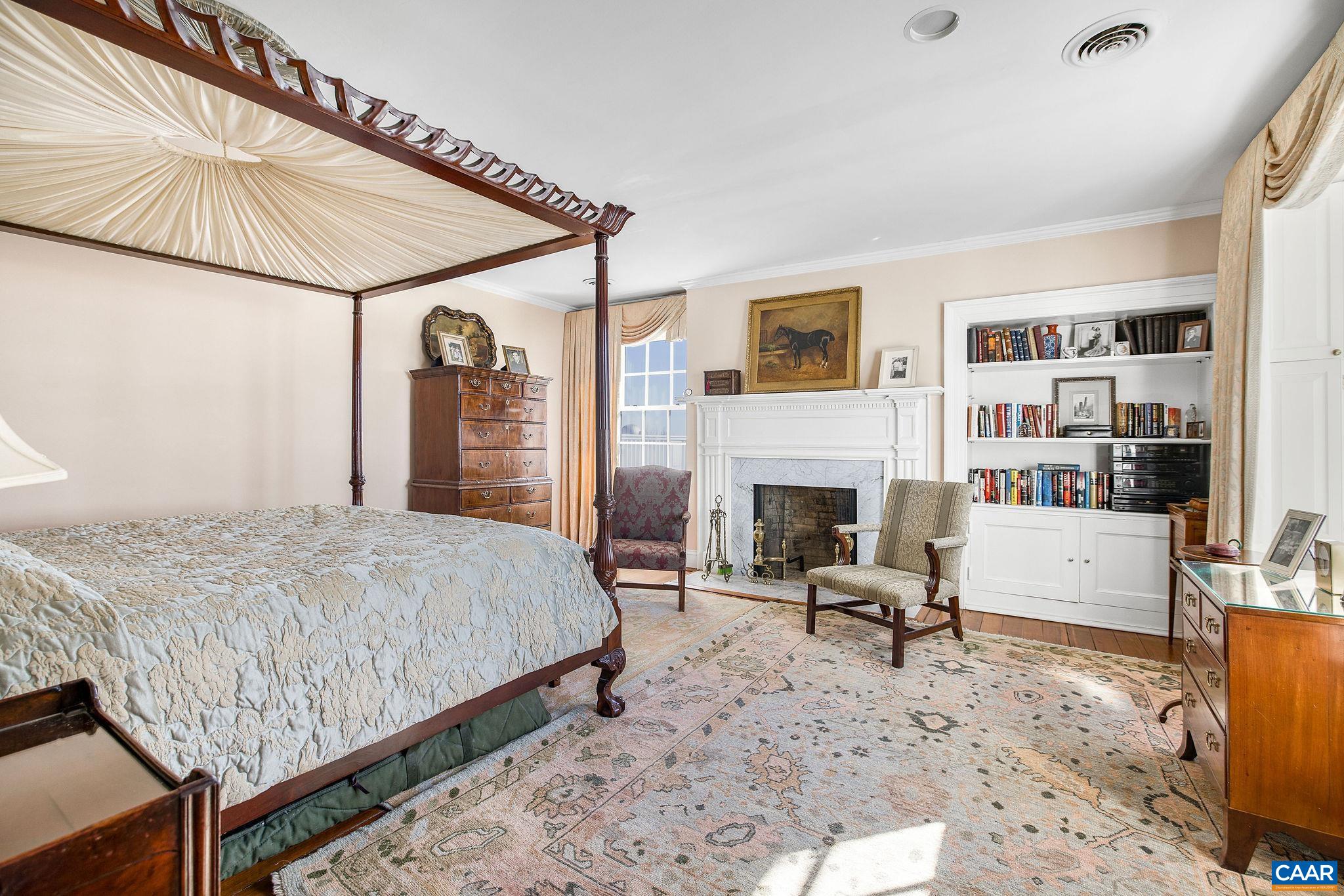 2328 Liberty Corner Road Esmont, VA 22937 - Photo 26 of 75 a bedroom with a bed a table and bookshelf