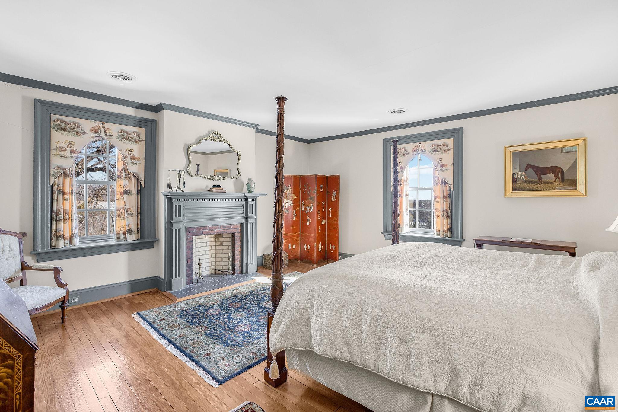 2328 Liberty Corner Road Esmont, VA 22937 - Photo 30 of 75 a bedroom with a large bed a flat tv screen and dresser