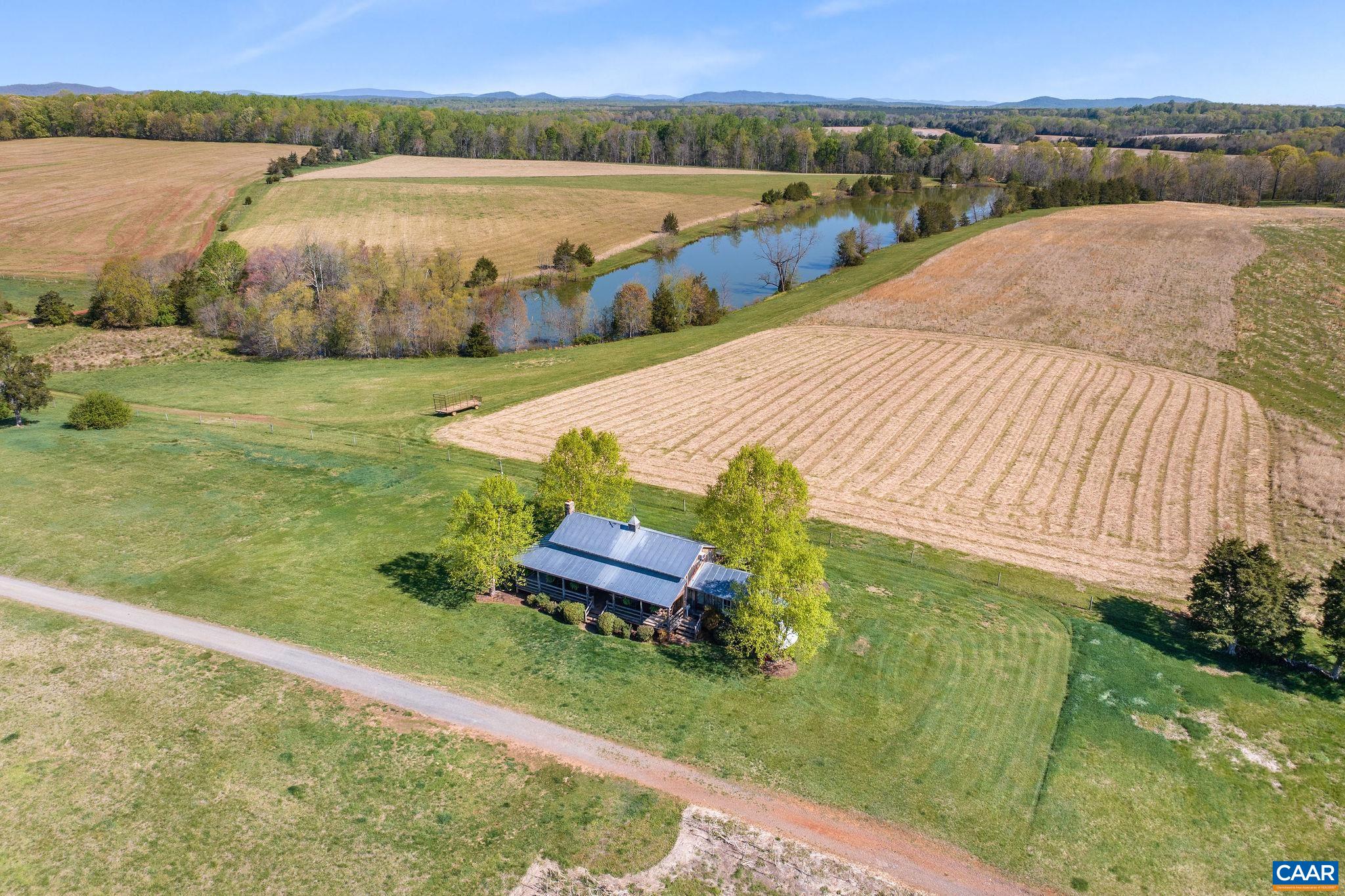 2328 Liberty Corner Road Esmont, VA 22937 - Photo 47 of 75 a view of a lake with a yard and a large window