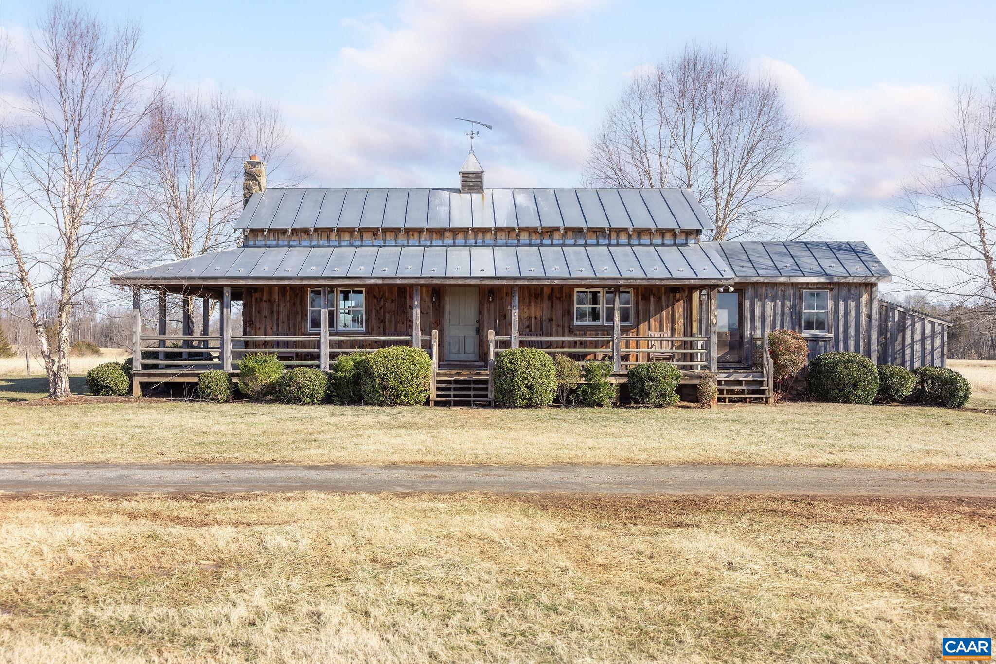 2328 Liberty Corner Road Esmont, VA 22937 - Photo 50 of 75 a front view of residential houses with yard and trees in the background