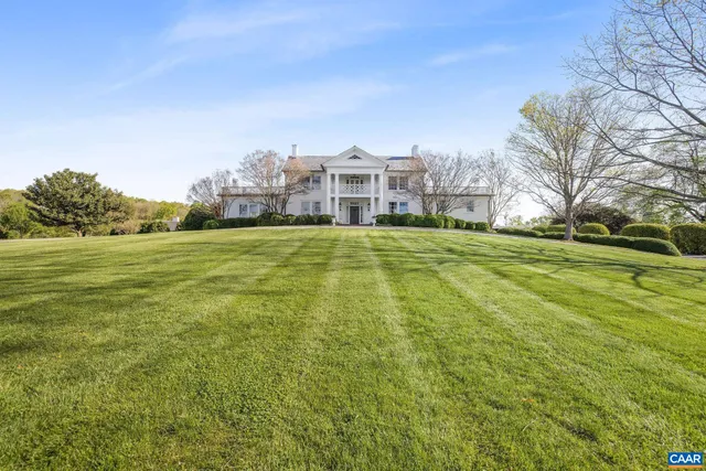 a front view of house with yard and trees