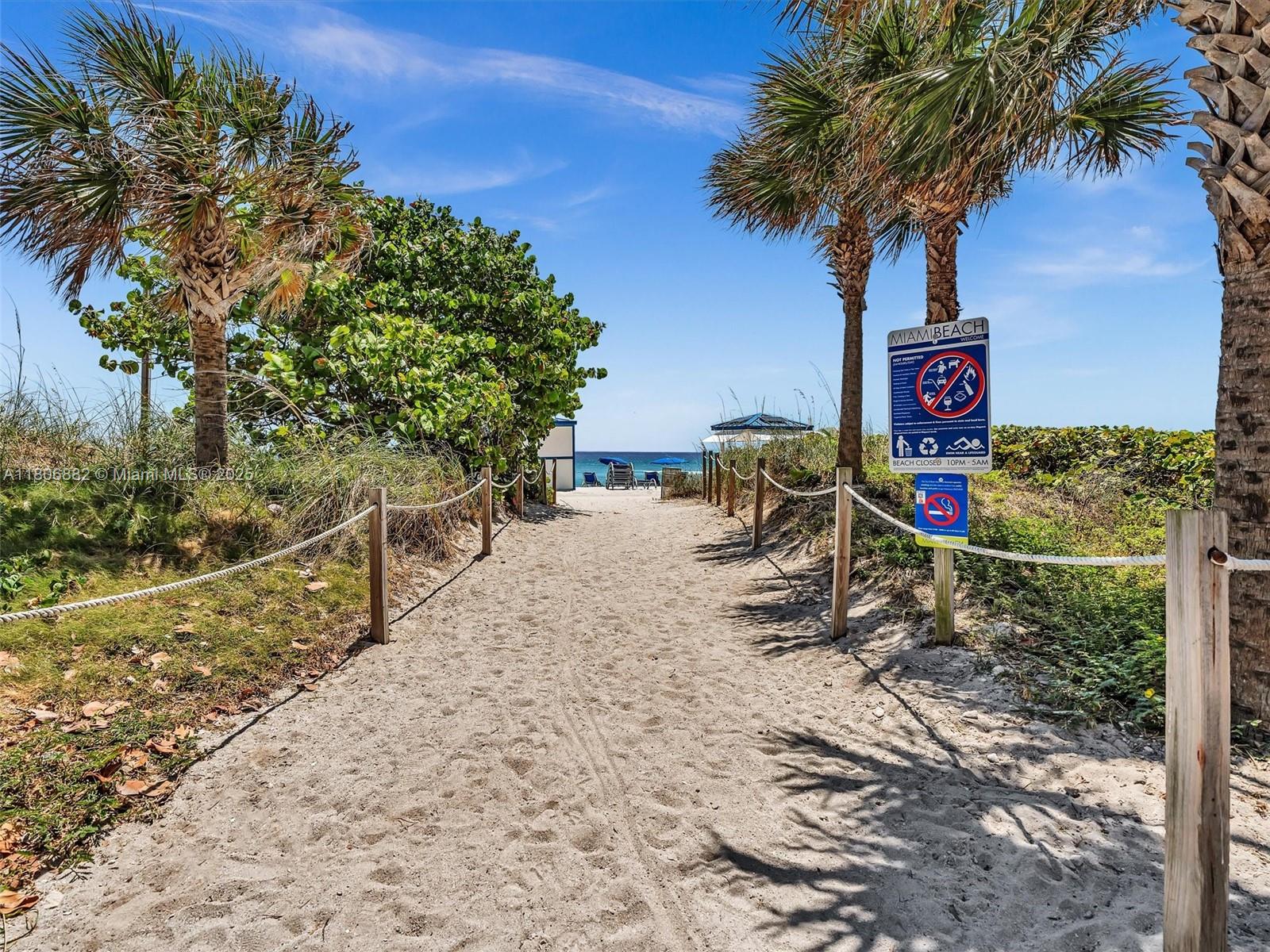 6423 Collins Avenue, Unit 409 Miami Beach, FL 33141 - Photo 1 of 66 a street sign on a sidewalk next to a road
