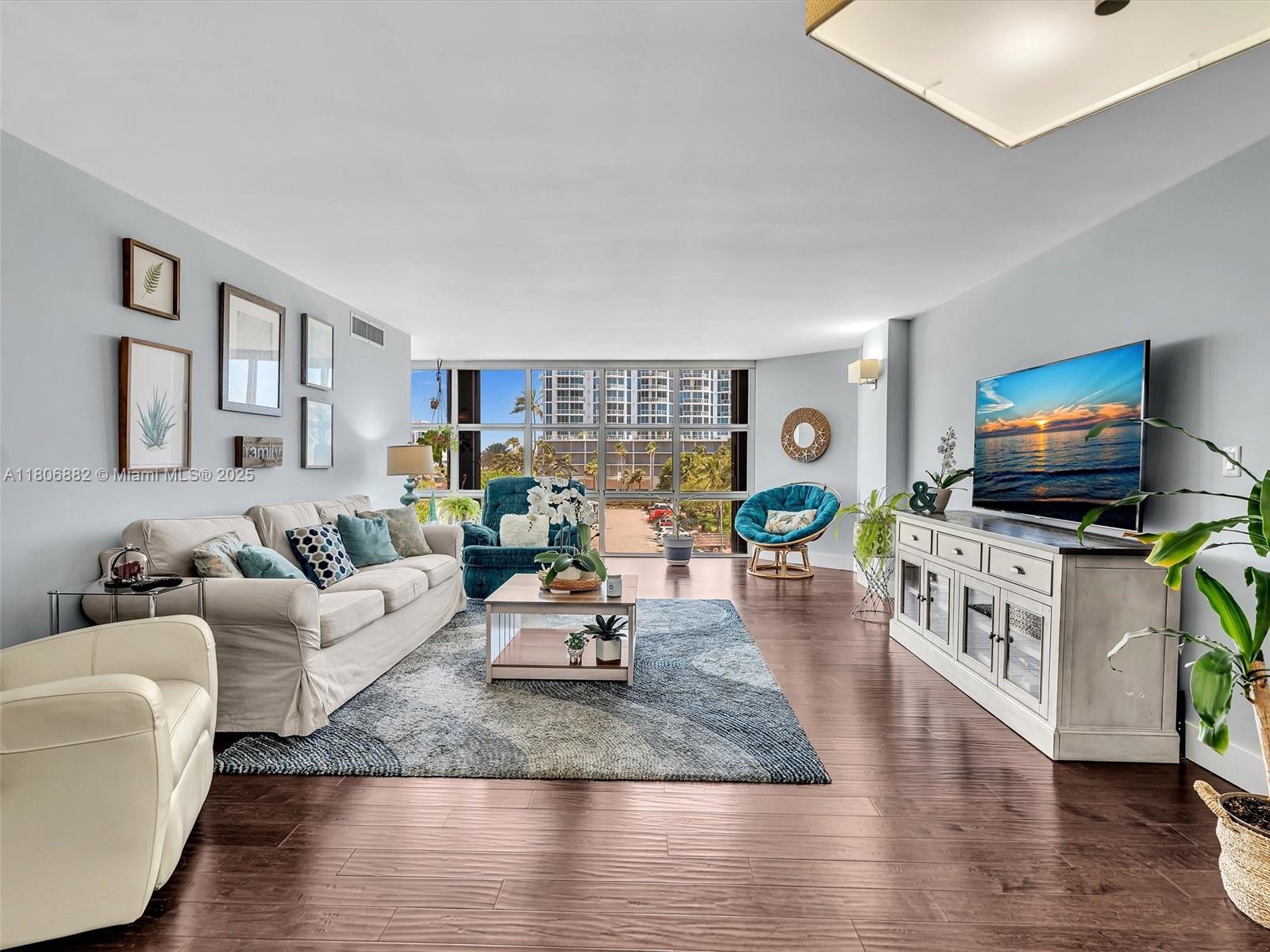 6423 Collins Avenue, Unit 409 Miami Beach, FL 33141 - Photo 19 of 66 a living room with fireplace furniture and a flat screen tv