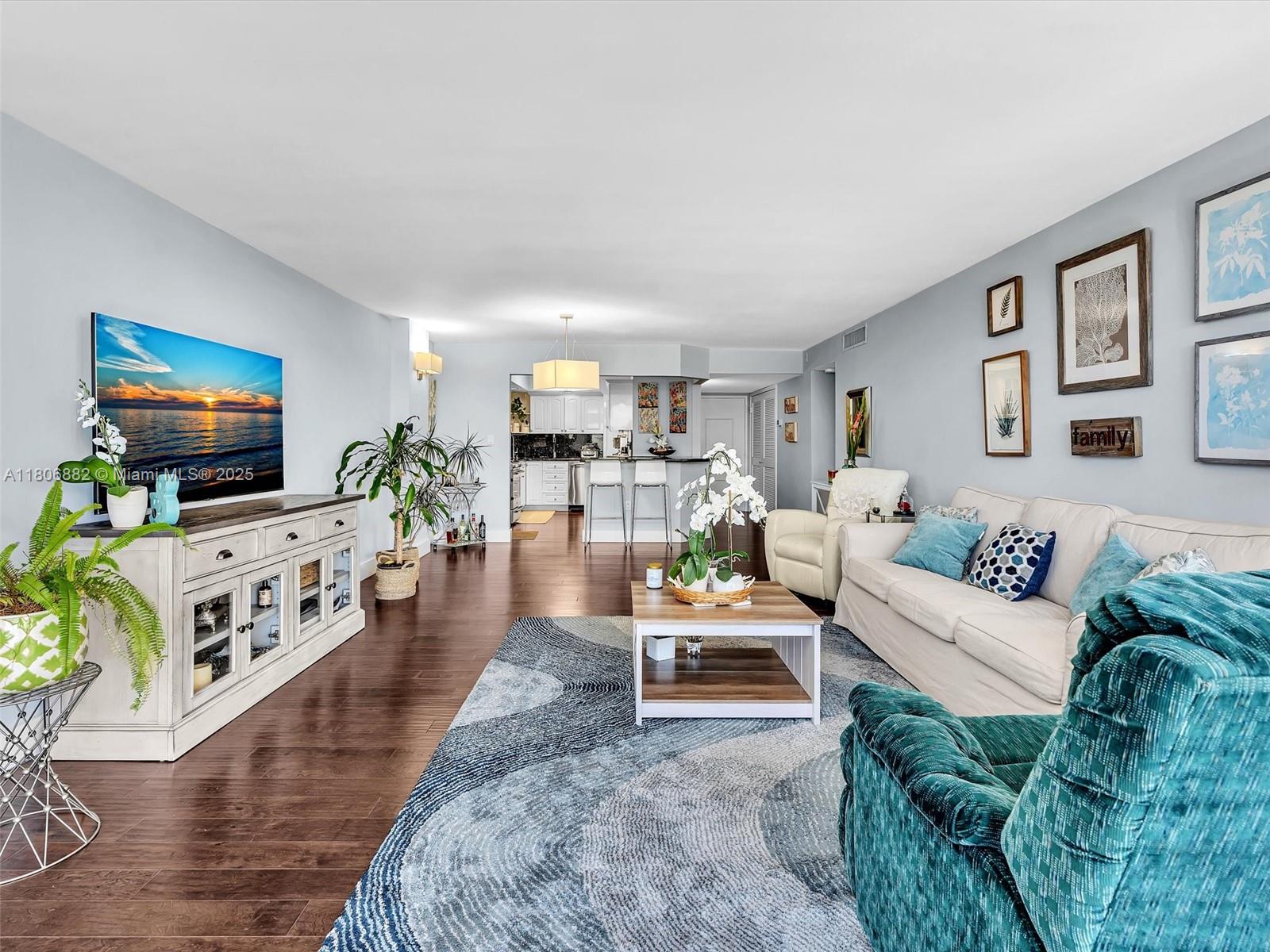 6423 Collins Avenue, Unit 409 Miami Beach, FL 33141 - Photo 24 of 66 a living room with furniture and a flat screen tv