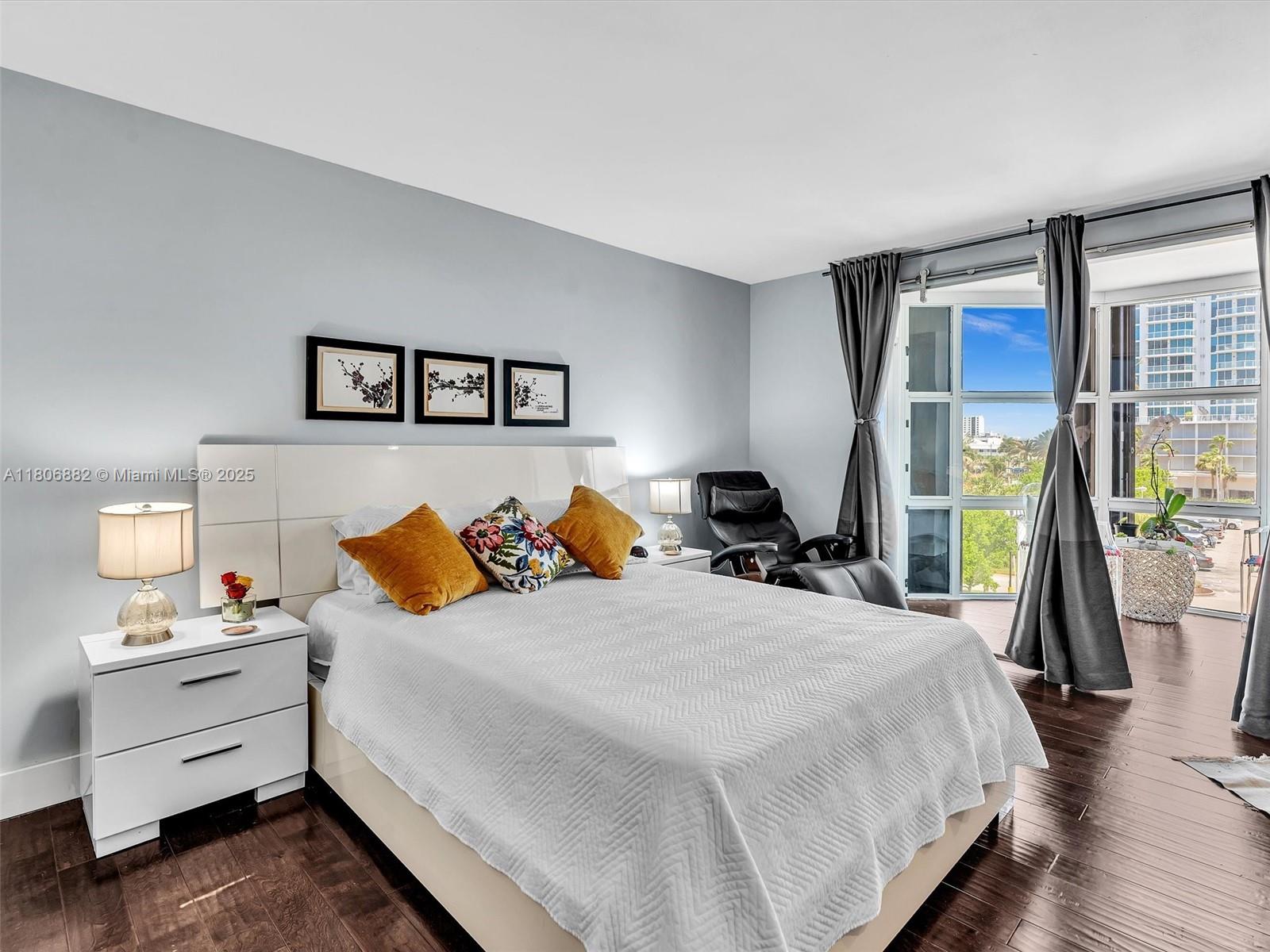 6423 Collins Avenue, Unit 409 Miami Beach, FL 33141 - Photo 27 of 66 a bed room with a bed and a night stand