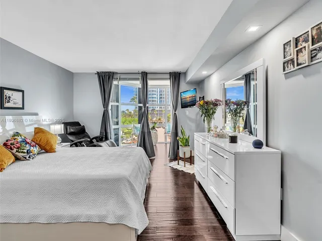 a bedroom with a large bed and a large window