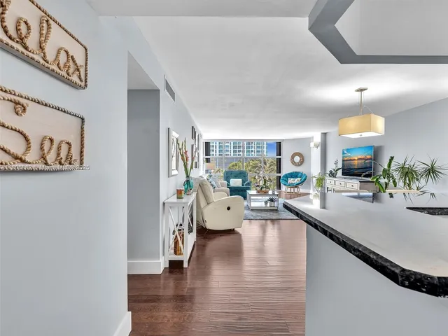 a kitchen with stainless steel appliances granite countertop a sink and chairs
