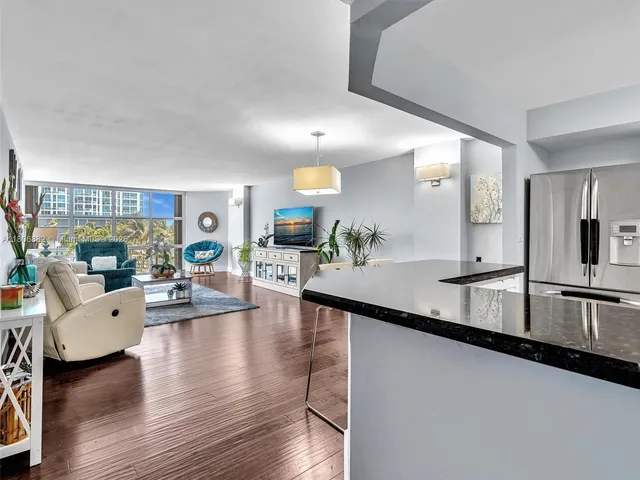 a kitchen with stainless steel appliances granite countertop a stove a sink and white cabinets