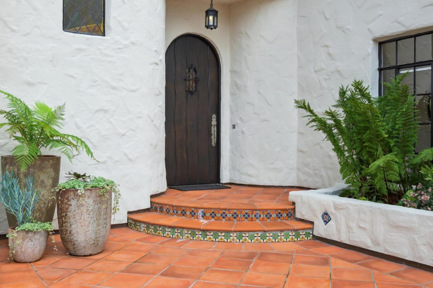 414 Edgewood Road San Mateo, CA 94402 - Photo 13 of 112 a front view of a house with potted plants