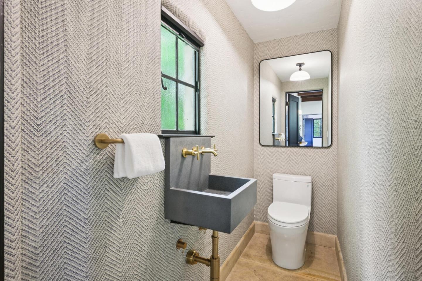 414 Edgewood Road San Mateo, CA 94402 - Photo 25 of 112 a white toilet sitting next to a bathroom sink