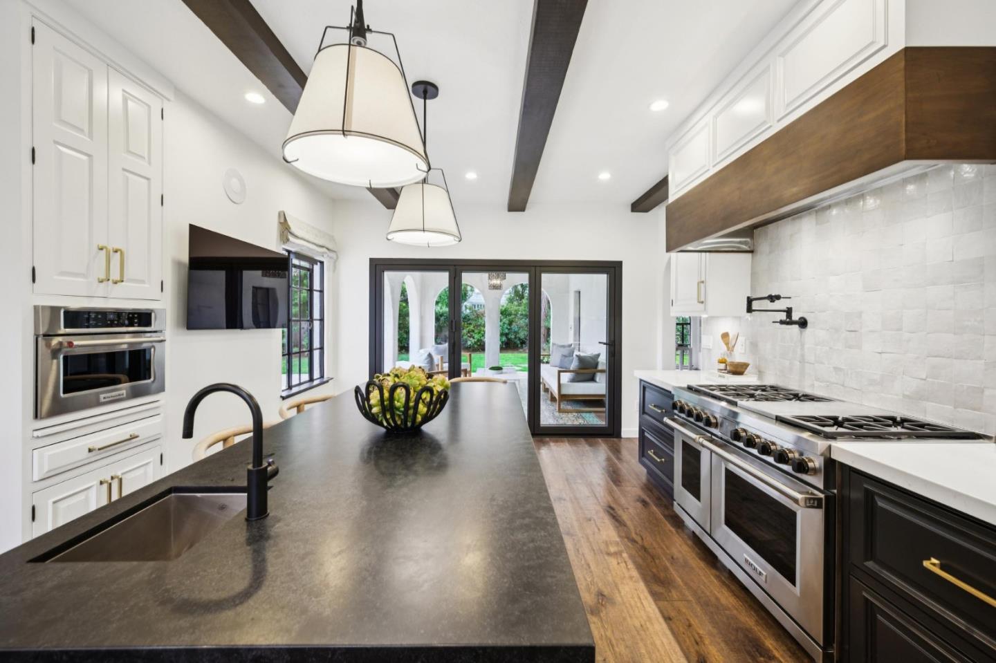 414 Edgewood Road San Mateo, CA 94402 - Photo 30 of 112 a kitchen with stainless steel appliances a stove a sink and a refrigerator
