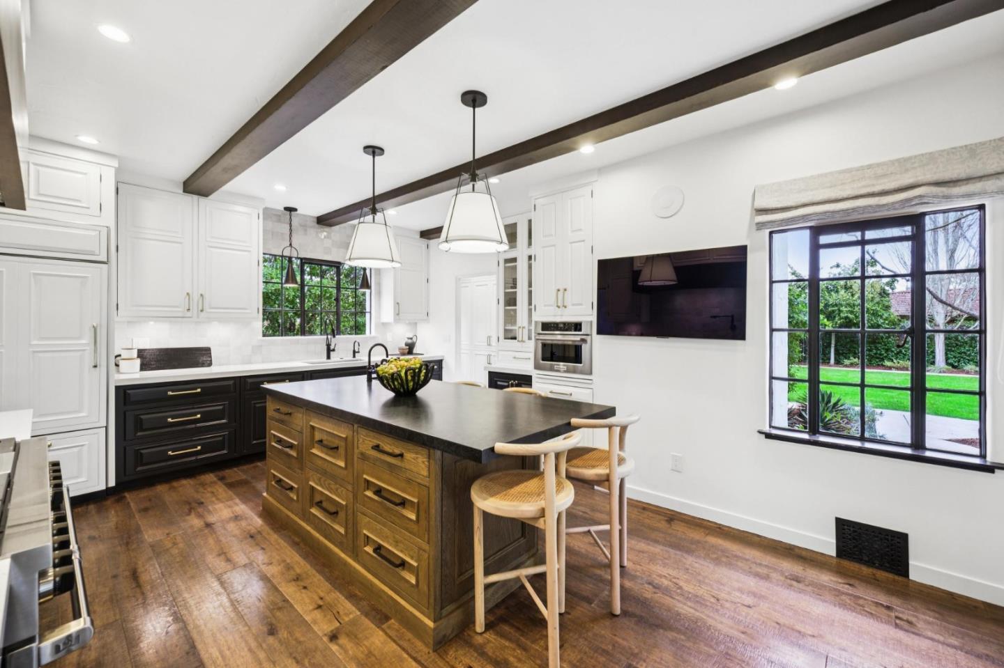 414 Edgewood Road San Mateo, CA 94402 - Photo 33 of 112 a kitchen with stainless steel appliances kitchen island granite countertop a stove a sink and a microwave