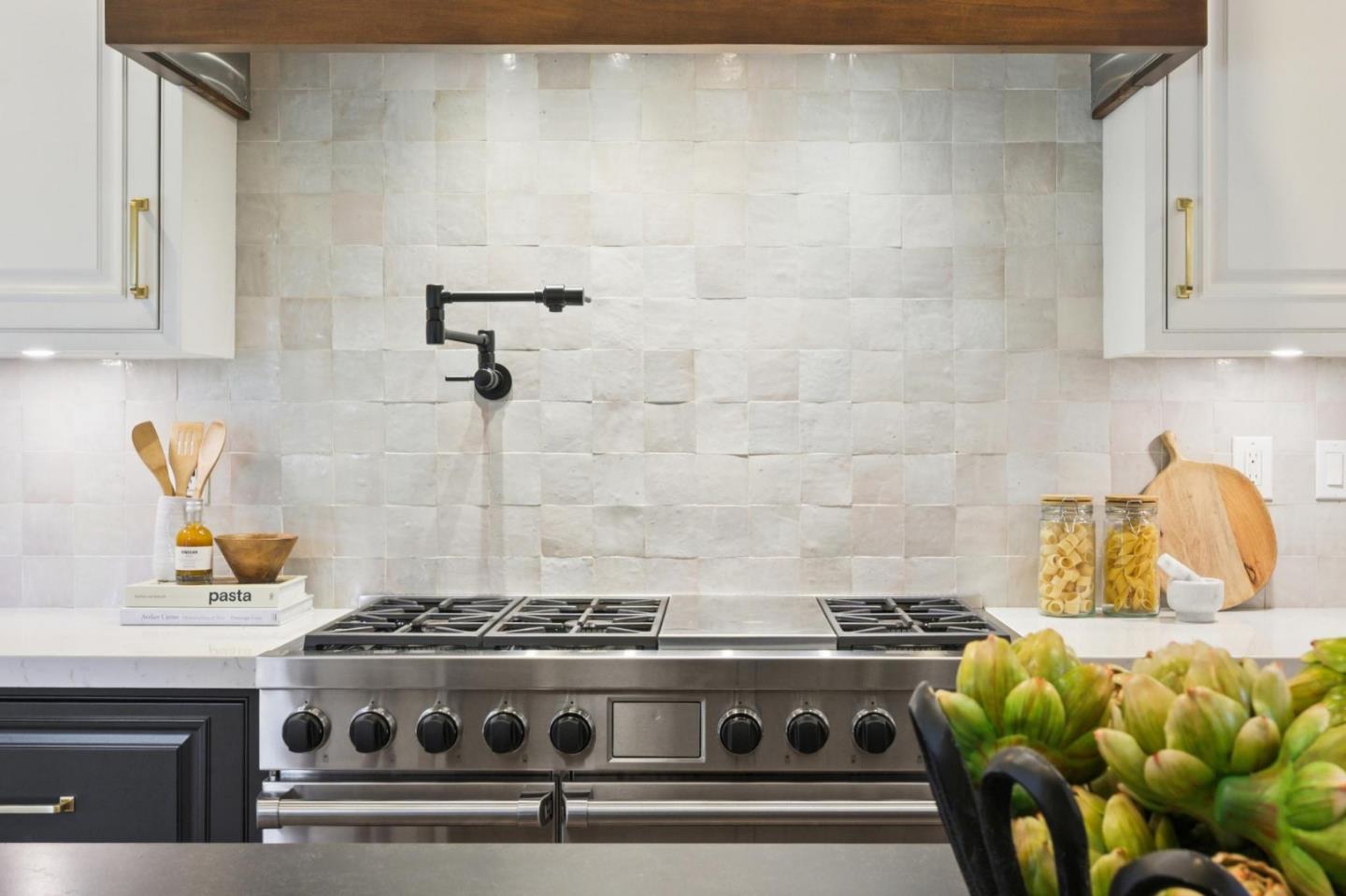 414 Edgewood Road San Mateo, CA 94402 - Photo 35 of 112 a stove sitting inside of a kitchen with white cabinets