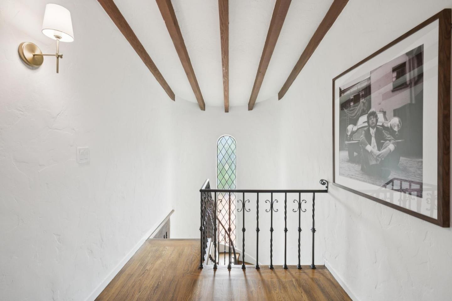 414 Edgewood Road San Mateo, CA 94402 - Photo 44 of 112 a view of a hallway with wooden floor and staircase