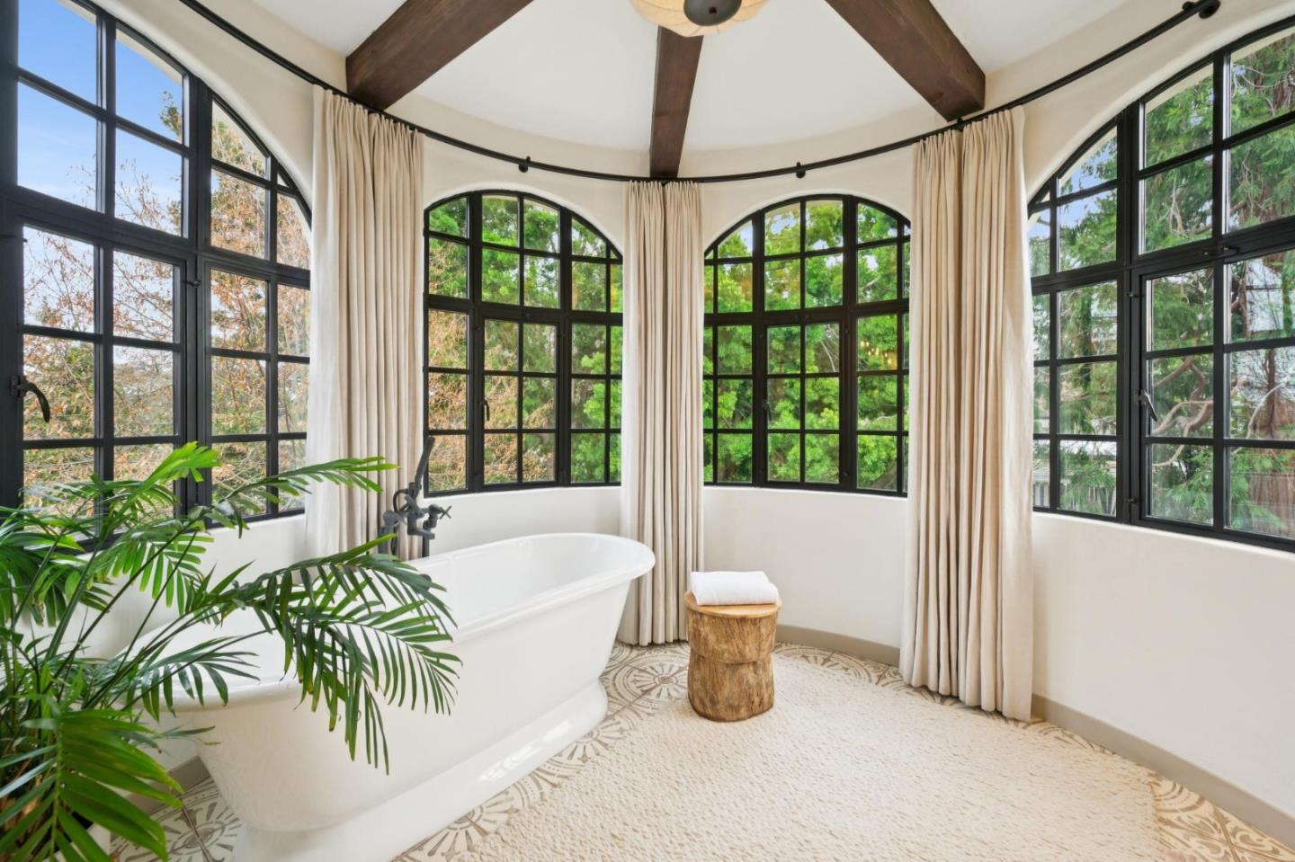 414 Edgewood Road San Mateo, CA 94402 - Photo 54 of 112 a very nice looking room with a large window and potted plants