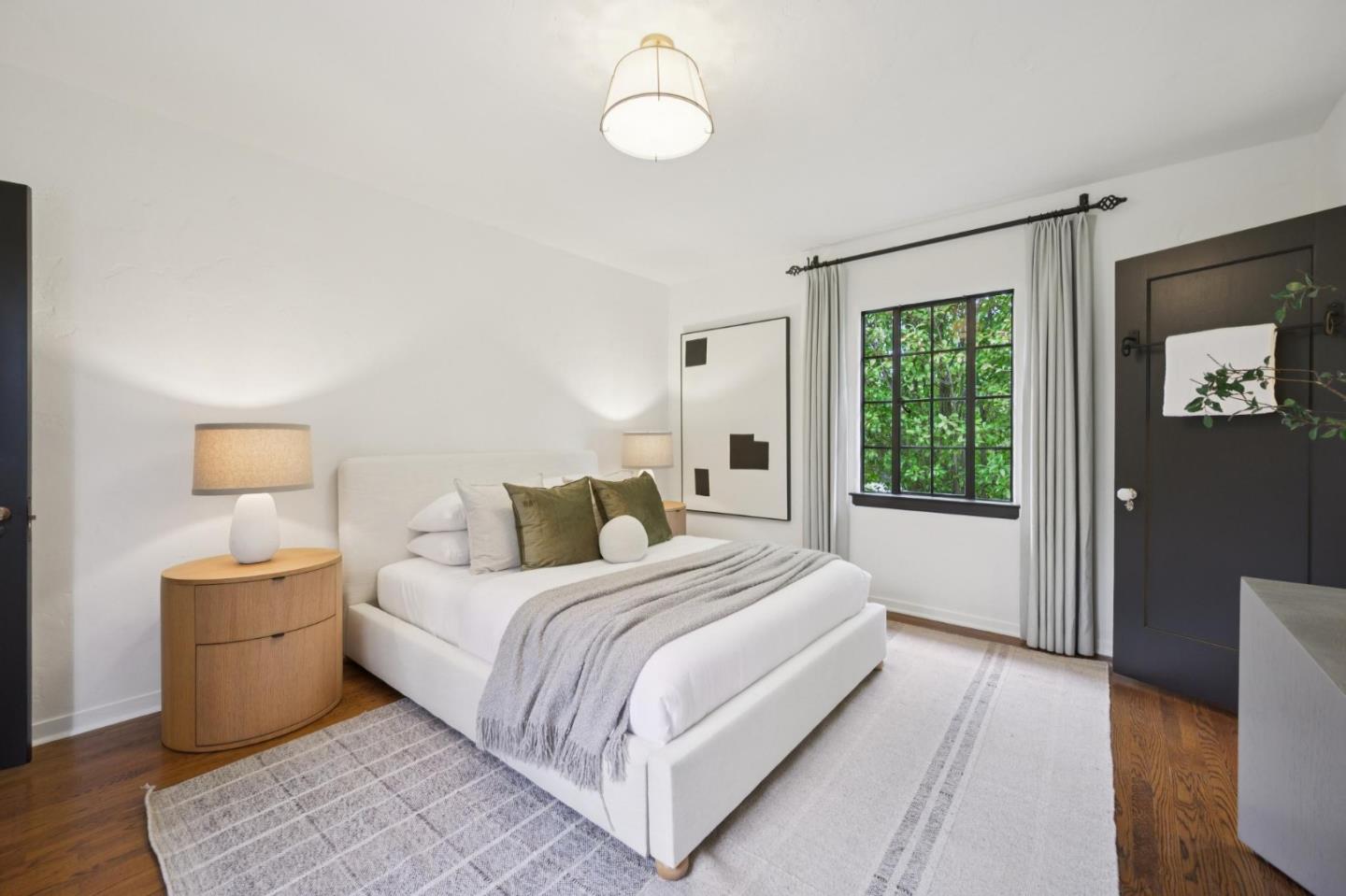 414 Edgewood Road San Mateo, CA 94402 - Photo 64 of 112 a bedroom with a large bed and a chandelier