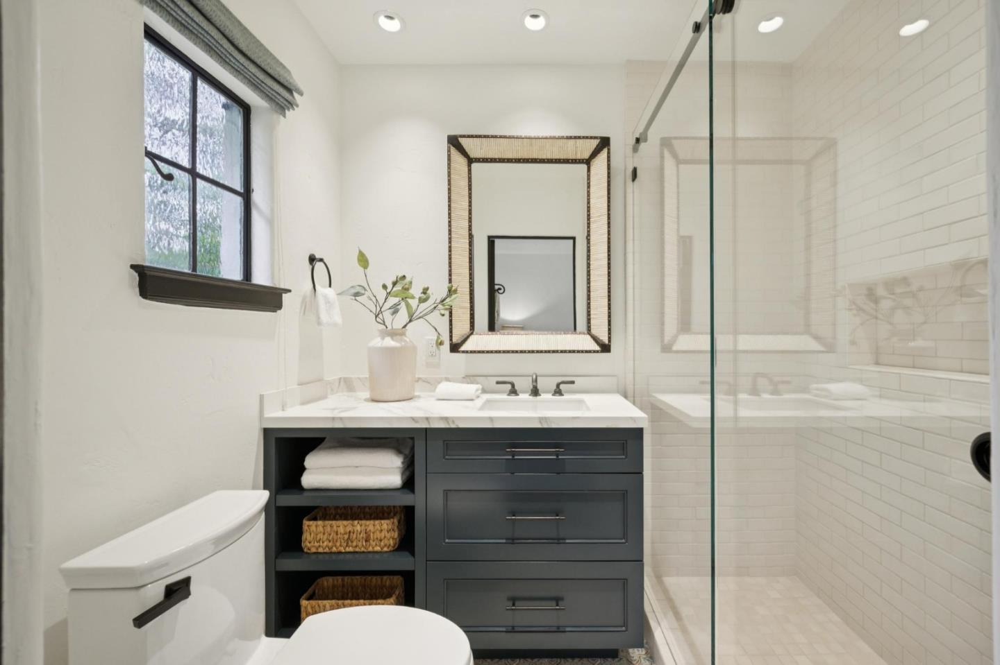 414 Edgewood Road San Mateo, CA 94402 - Photo 68 of 112 a bathroom with a sink a toilet a large mirror and shower