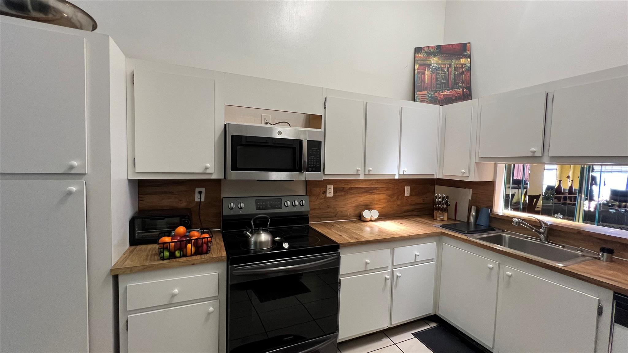 Undisclosed Address Miami, FL 33179 - Photo 11 of 15 a kitchen with a sink and a stove top oven