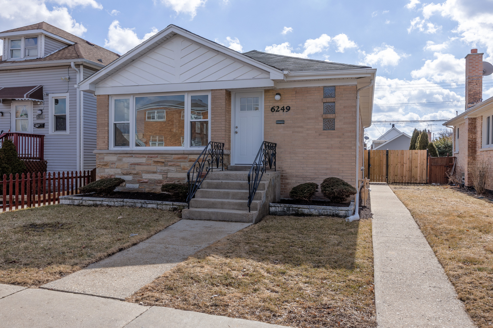 a view of a house with a yard and sitting area