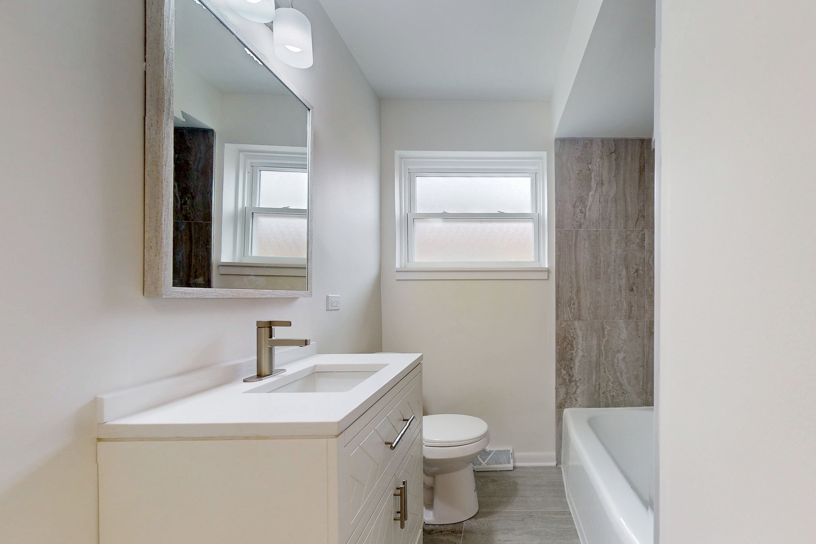 6249 West Addison Street Chicago, IL 60634 - Photo 12 of 35 a bathroom with a sink a toilet and shower