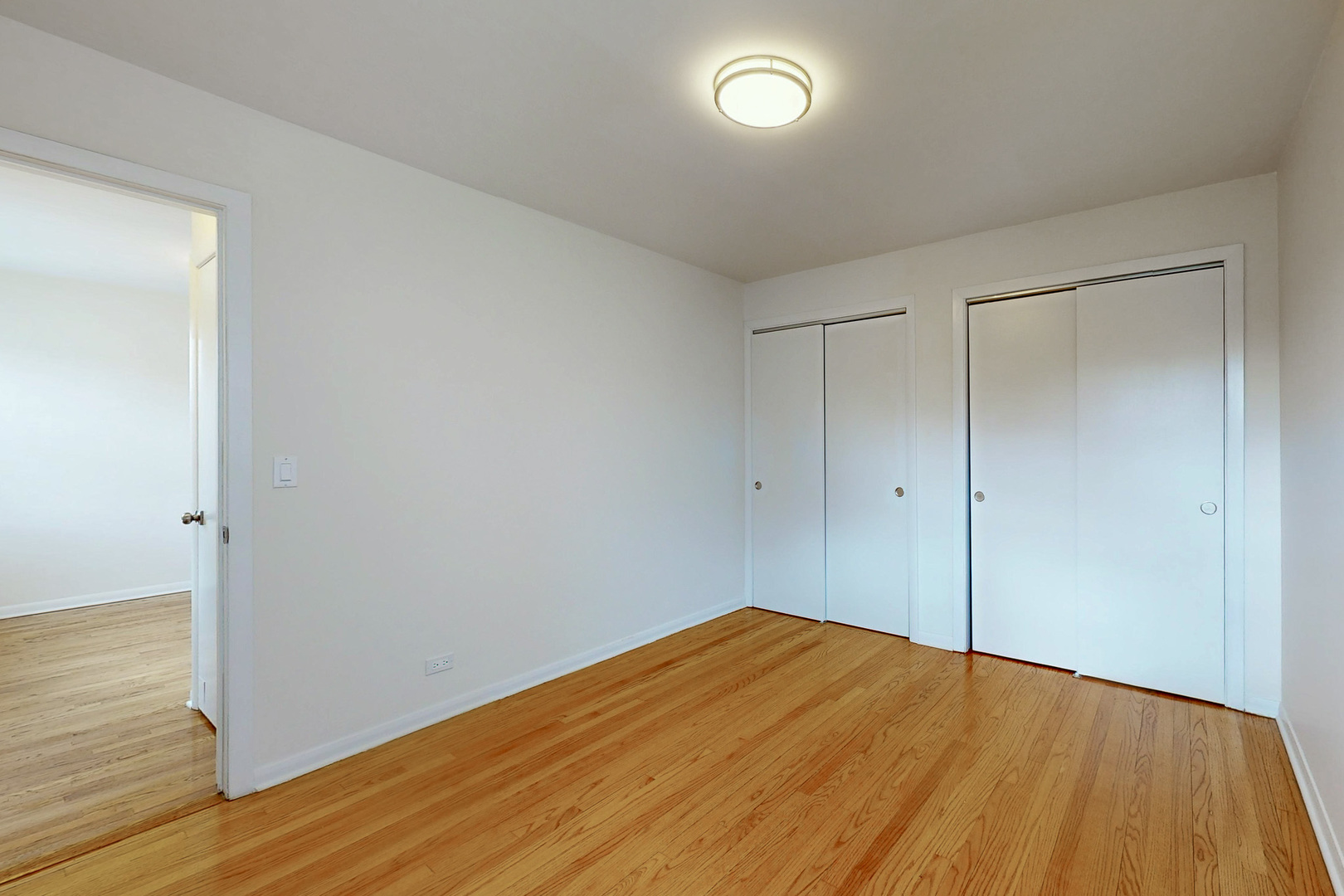 6249 West Addison Street Chicago, IL 60634 - Photo 14 of 35 a view of empty room with wooden floor