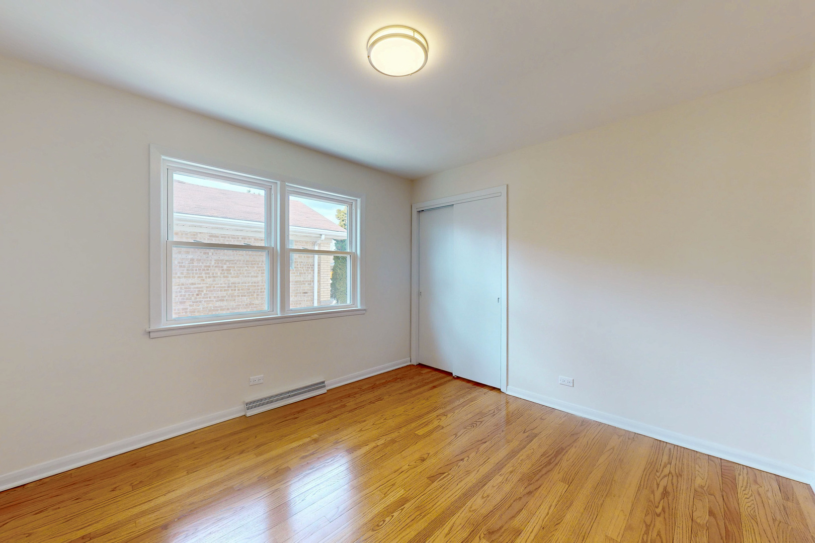 6249 West Addison Street Chicago, IL 60634 - Photo 18 of 35 an empty room with wooden floor and windows