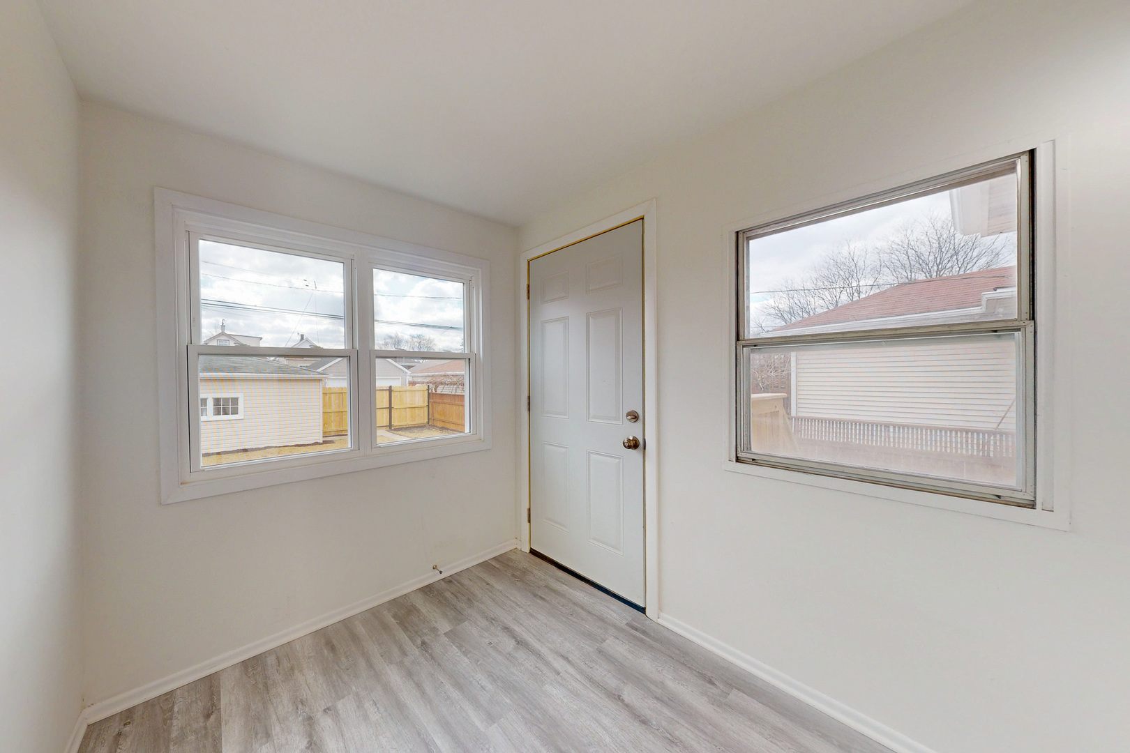 6249 West Addison Street Chicago, IL 60634 - Photo 19 of 35 an empty room with wooden floor and windows