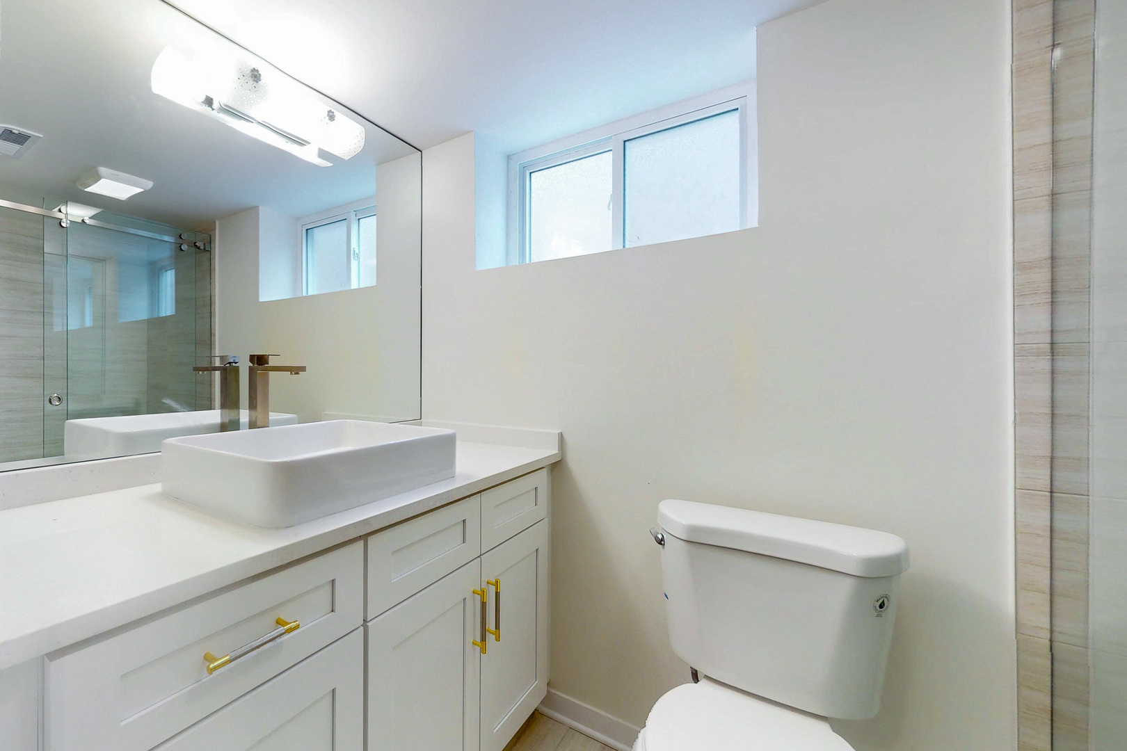 6249 West Addison Street Chicago, IL 60634 - Photo 23 of 35 a bathroom with a toilet sink and mirror