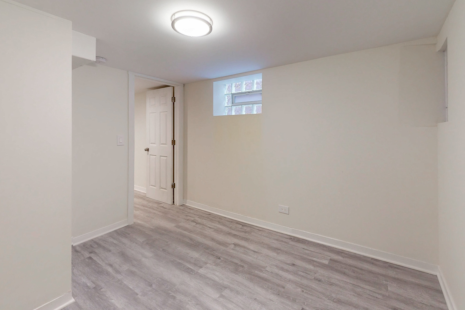6249 West Addison Street Chicago, IL 60634 - Photo 31 of 35 a view of an empty room with wooden floor and a window